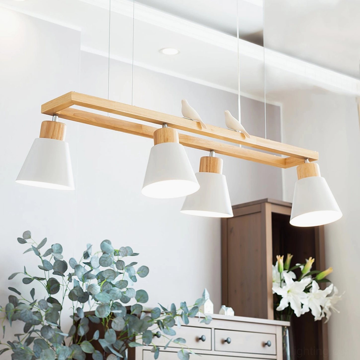 Nordic minimalist wooden pendant chandelier with bird decorative accents in home interior with green plants
