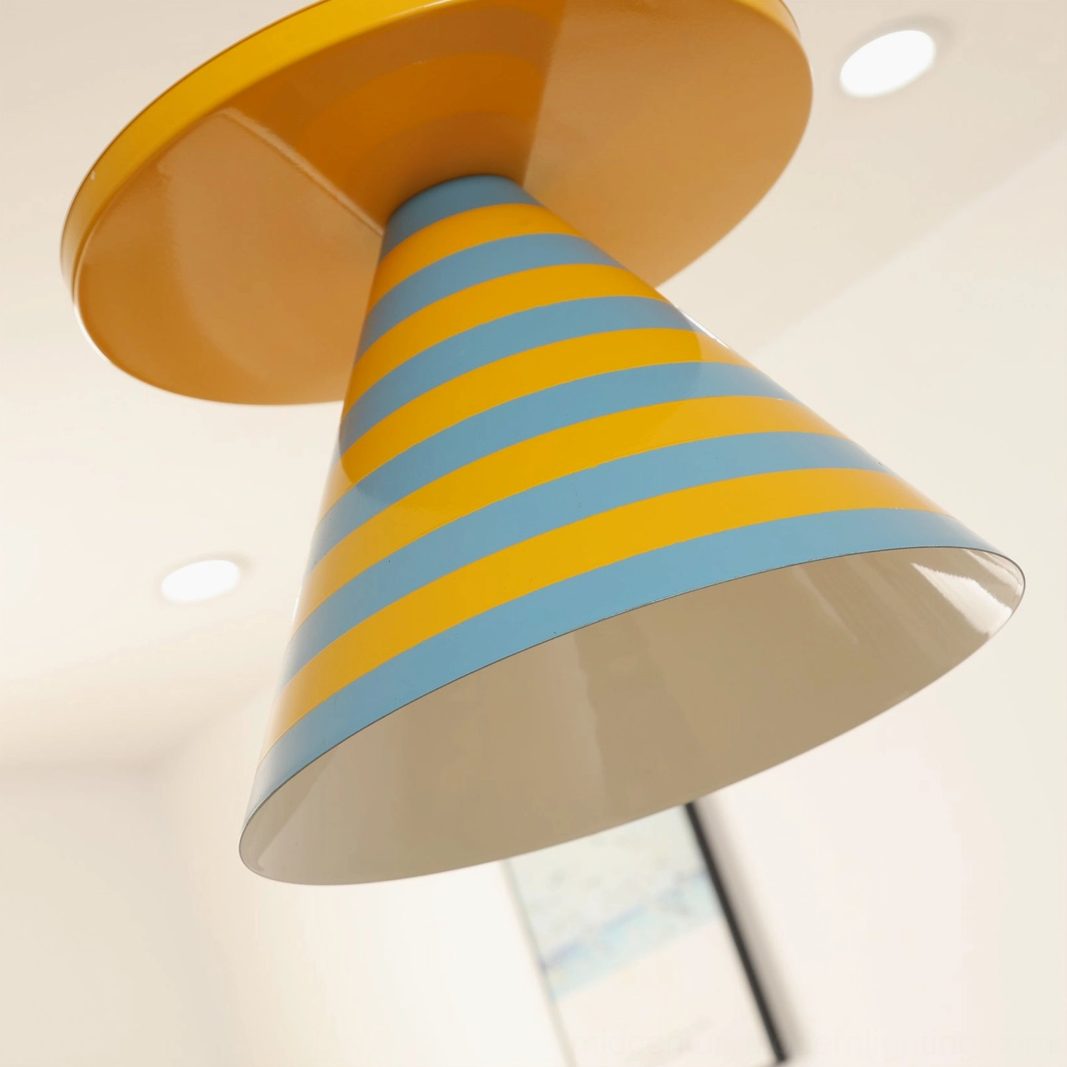 Close-up side view of striped cone lampshade interior showing glossy acrylic finish and light diffusion quality