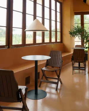 Cone Washi Pendant Light hanging in warm vintage cafe interior with wooden windows and soft ambient lighting