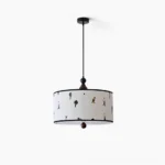 Congo drum pendant light with whimsical cartoon fabric shade and black trim, front view on white background