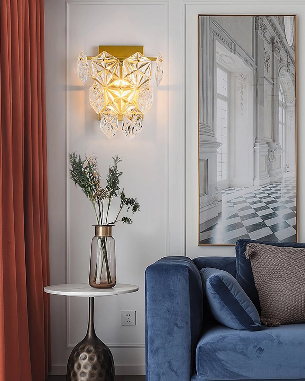 Faceted crystal wall lamp in contemporary living room with blue velvet sofa and side table styling