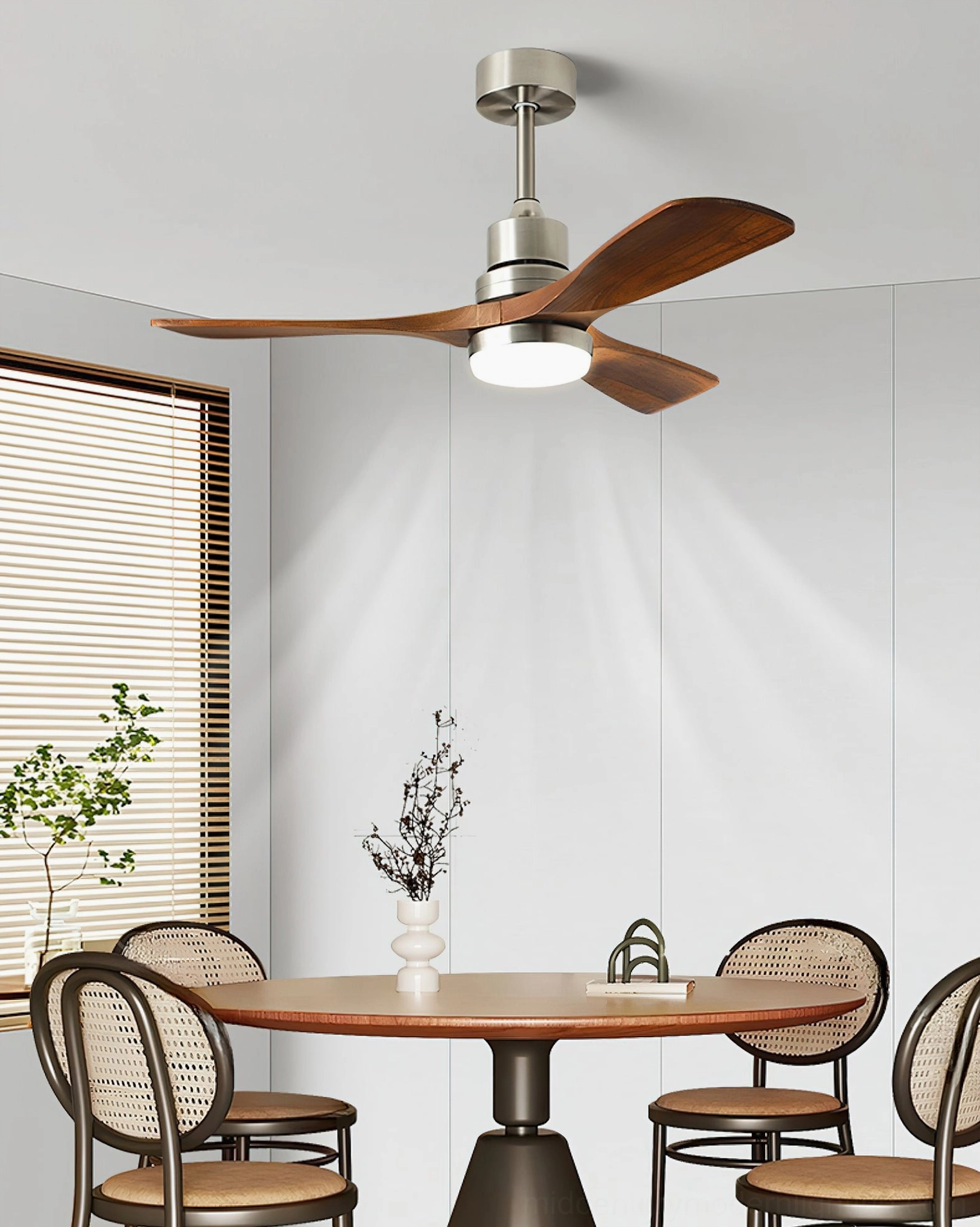 Contemporary ceiling fan light with adjustable LED installed in small dining nook with round wood table and rattan dining chairs