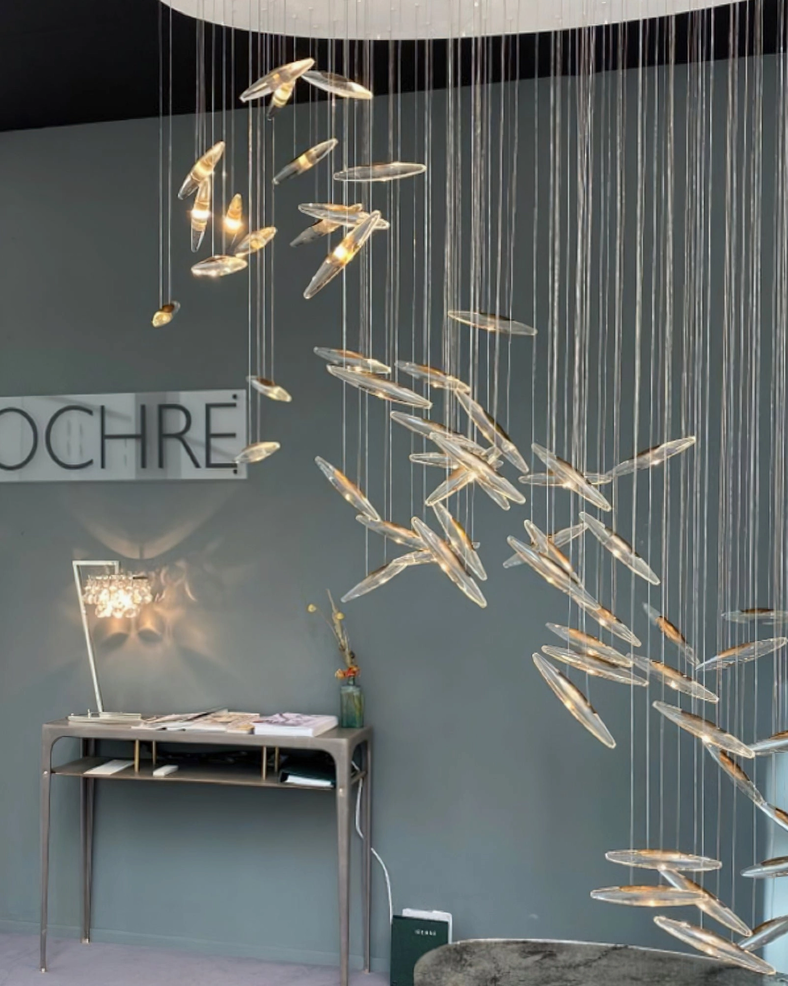 Contemporary glass pendant chandelier with warm ambient lighting in luxury interior space