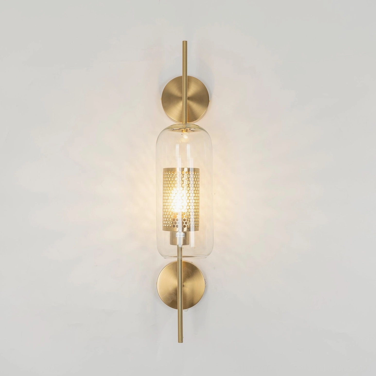 Contemporary glass sconce showing clear glass and metal hardware detail view