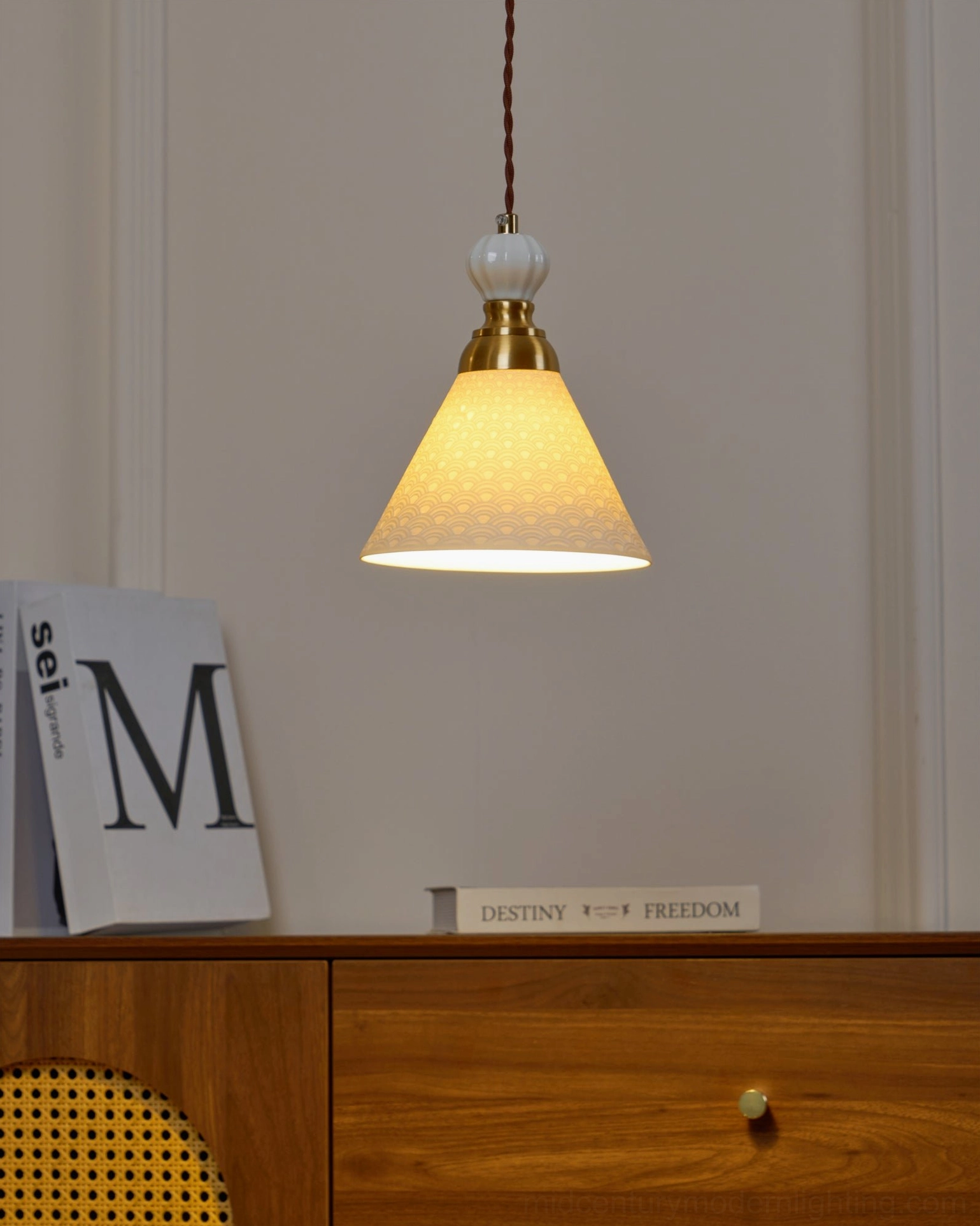 Contemporary handmade ceramic pendant featuring organic sculptural forms and brass accents