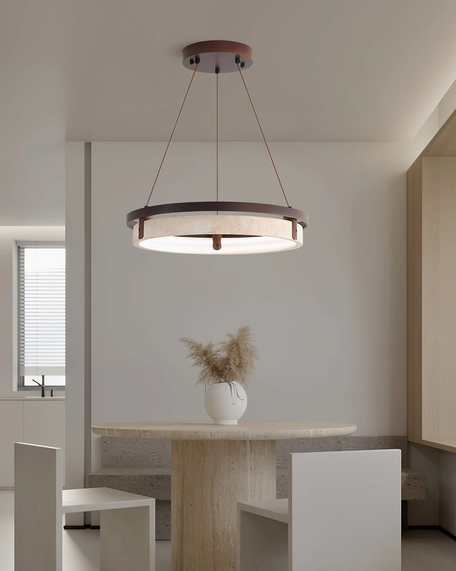 Contemporary dining area with travertine ring pendant light above stone table with dried flower arrangement