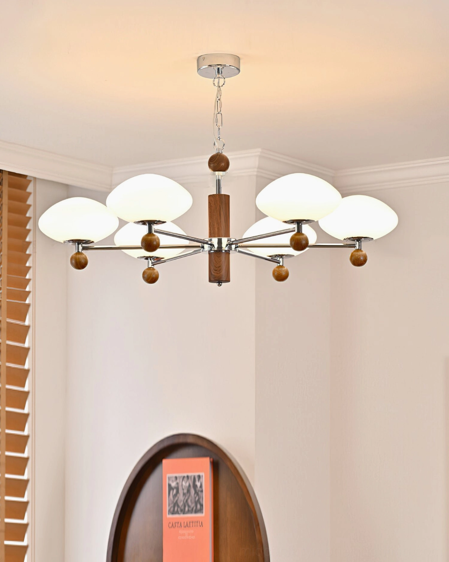 Contemporary pointed chandelier in minimalist interior - sleek mid-century modern pendant with arched wall decor