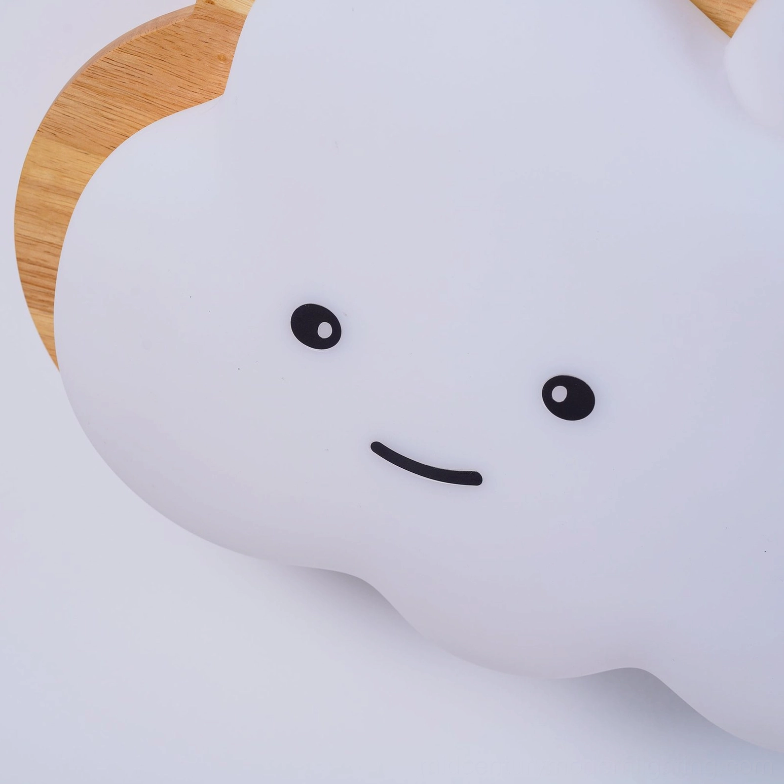 Contemporary smiling cloud lamp installed in minimalist Nordic kids room with natural light accents