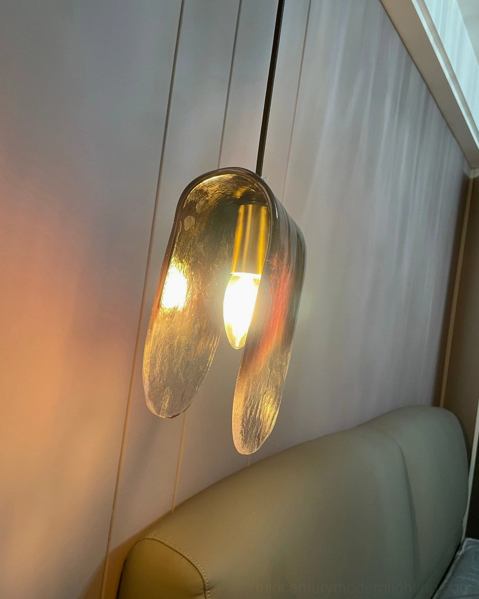 Contemporary pendant light design combining artistic glass work with industrial metal elements