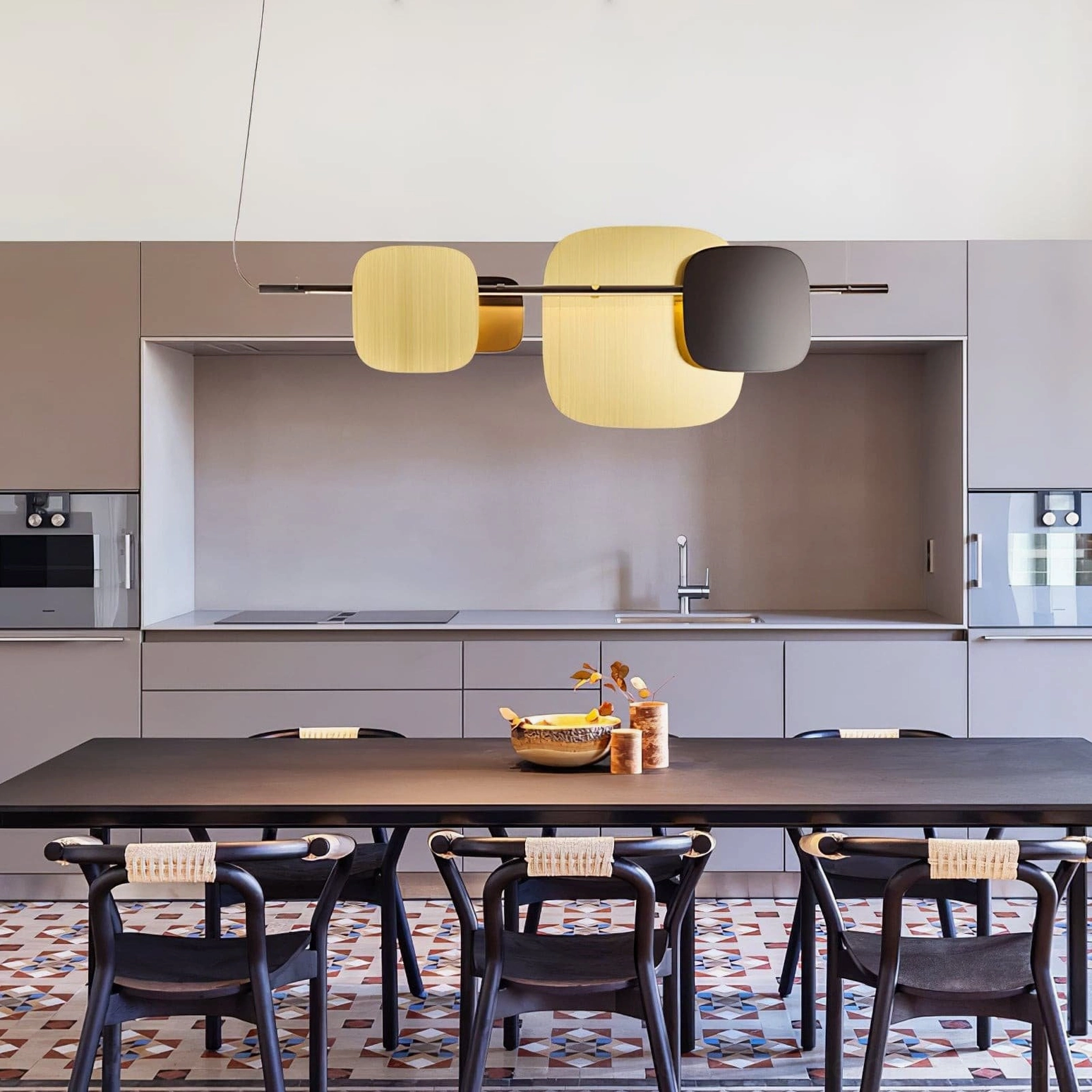 Contemporary geometric pendant light hanging in family dining kitchen, luxury minimalist fixture