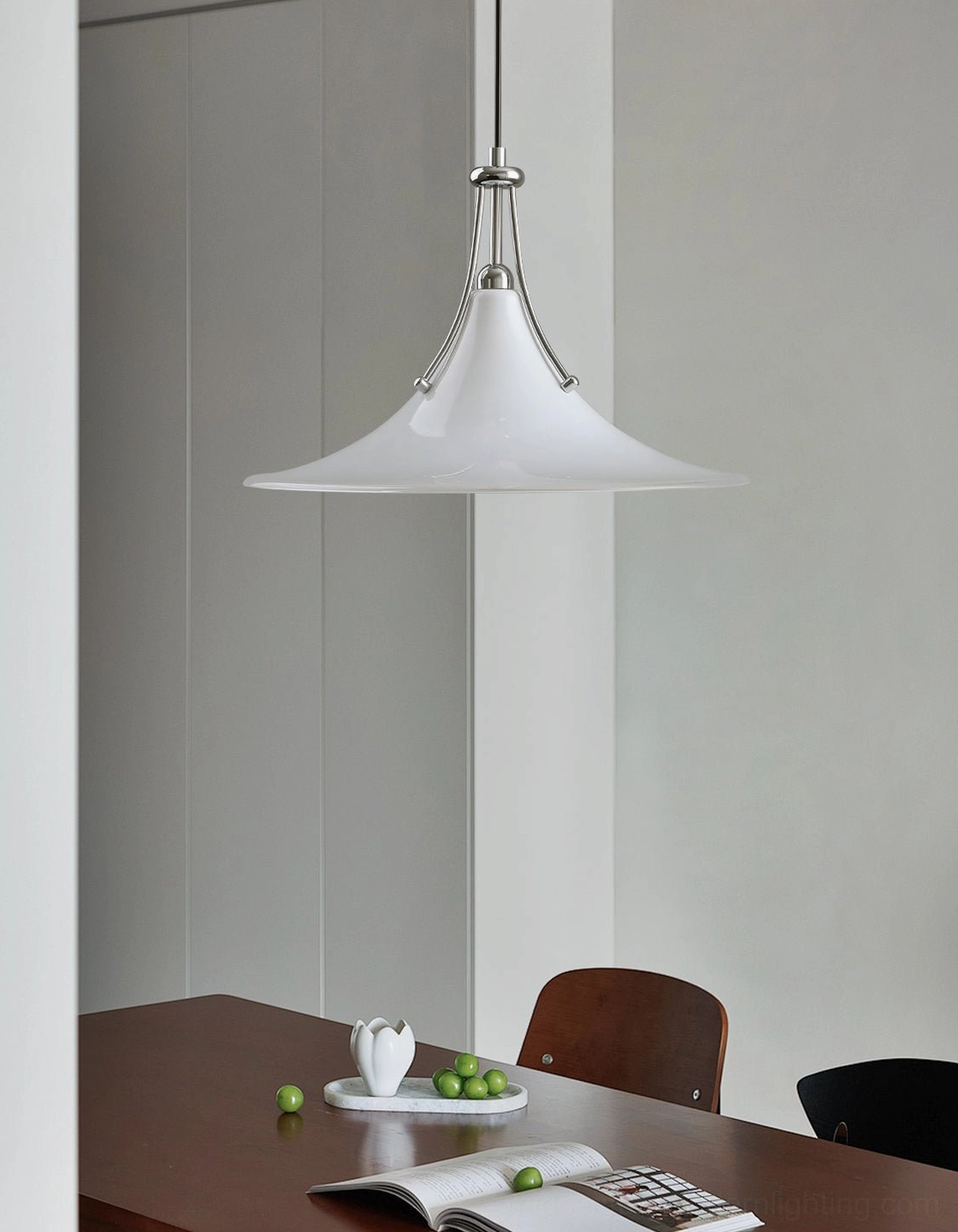 Contemporary swing arm pendant fixture in sleek minimalist dining area, demonstrating directional light control and clean design lines