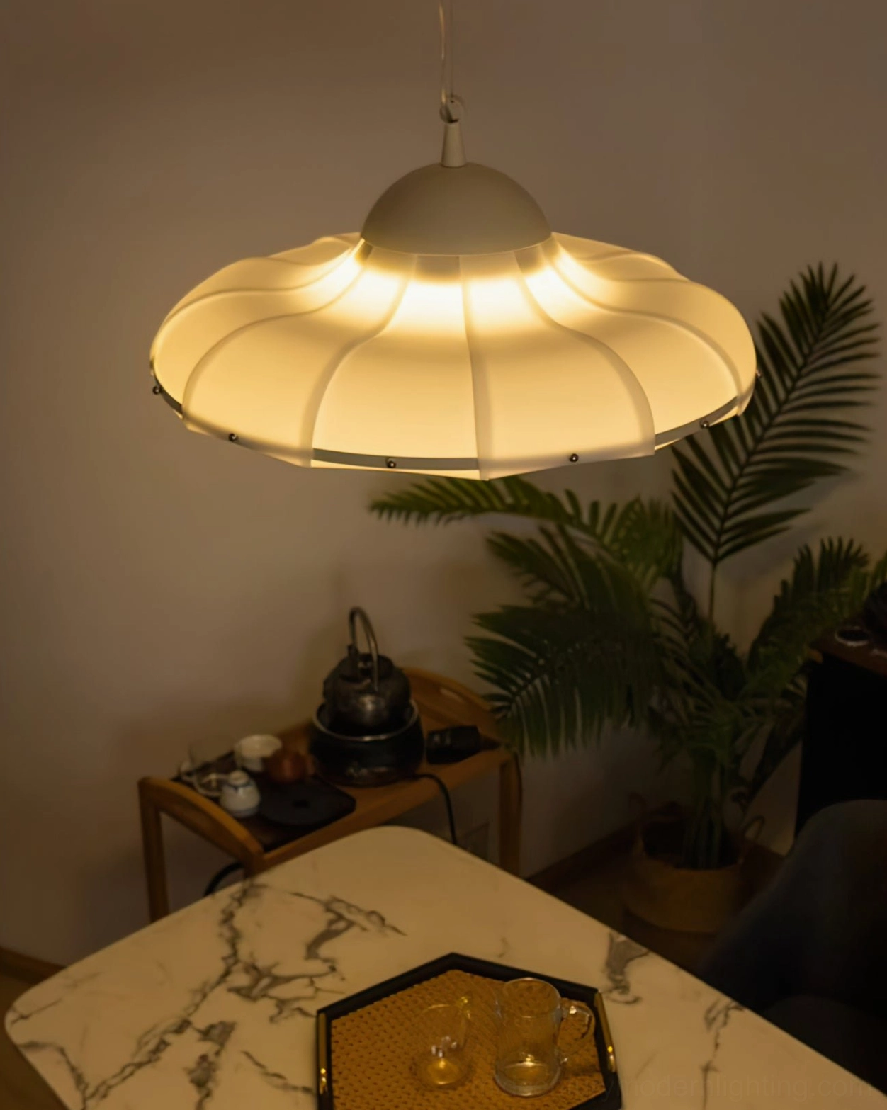 Contemporary swirl pendant lamp positioned as focal point in modern minimalist interior setting
