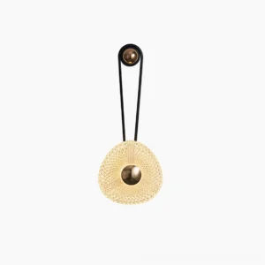 Contemporary wall-mounted sconce with leather accent strap and woven glass diffuser, minimalist design detail