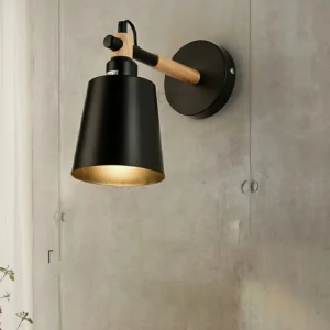 Copita wall lamp three-quarter perspective showing rotatable metal shade and articulated wood joint design