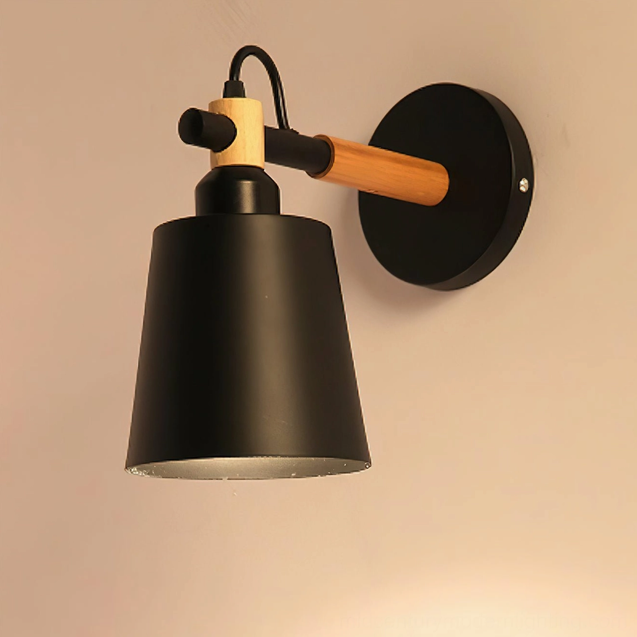 Close-up detail of Copita wall lamp rotatable joint showing exposed E27 bulb socket and wood-metal connection