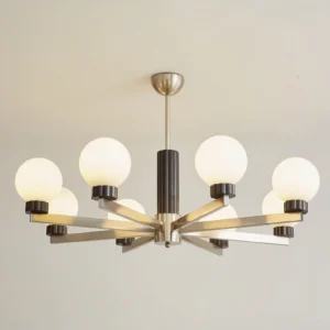Close-up overhead view of mid-century modern multi-arm pendant chandelier with warm brushed metal arms and frosted glass globes