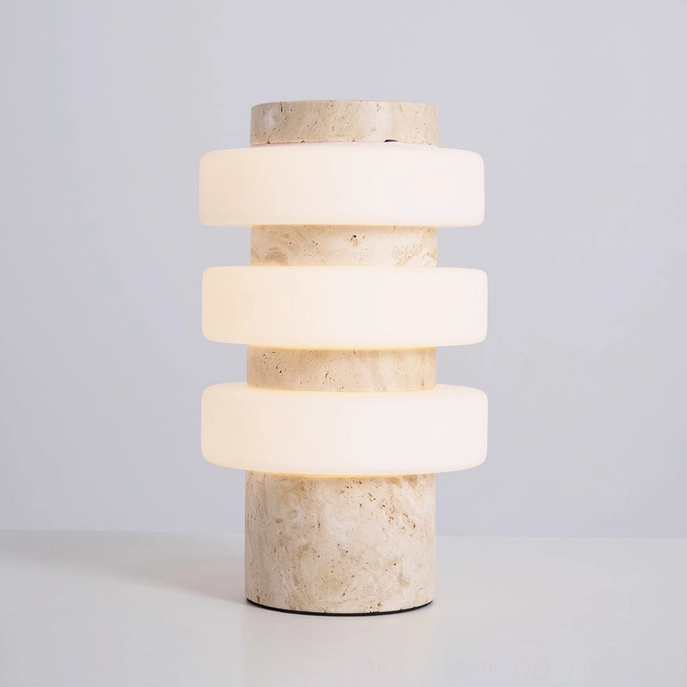 Corba table lamp with marble base and illuminated stacked glass creating soft ambient lighting