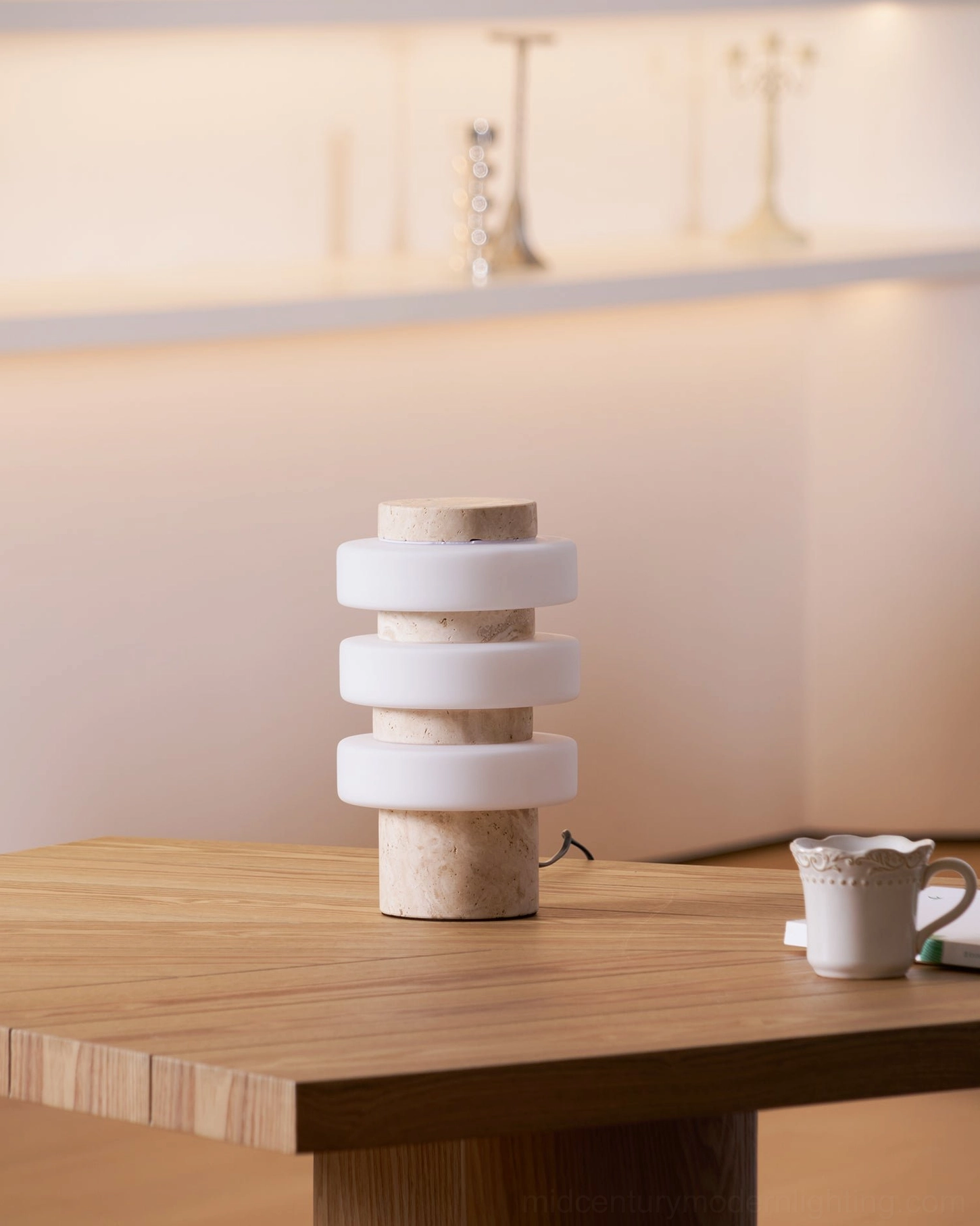 Corba sculptural table lamp with natural stone base three-quarter view showing glass ring stacking