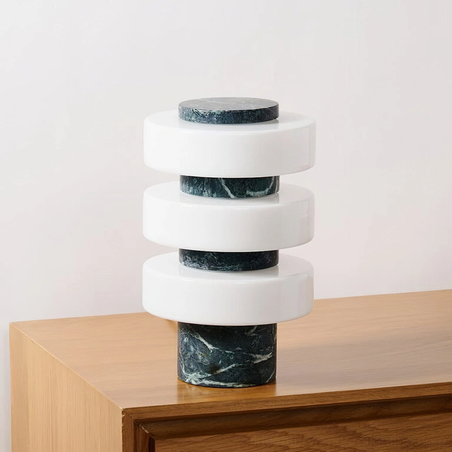 Corba sculptural marble table lamp with stacked glass rings creating geometric light pattern