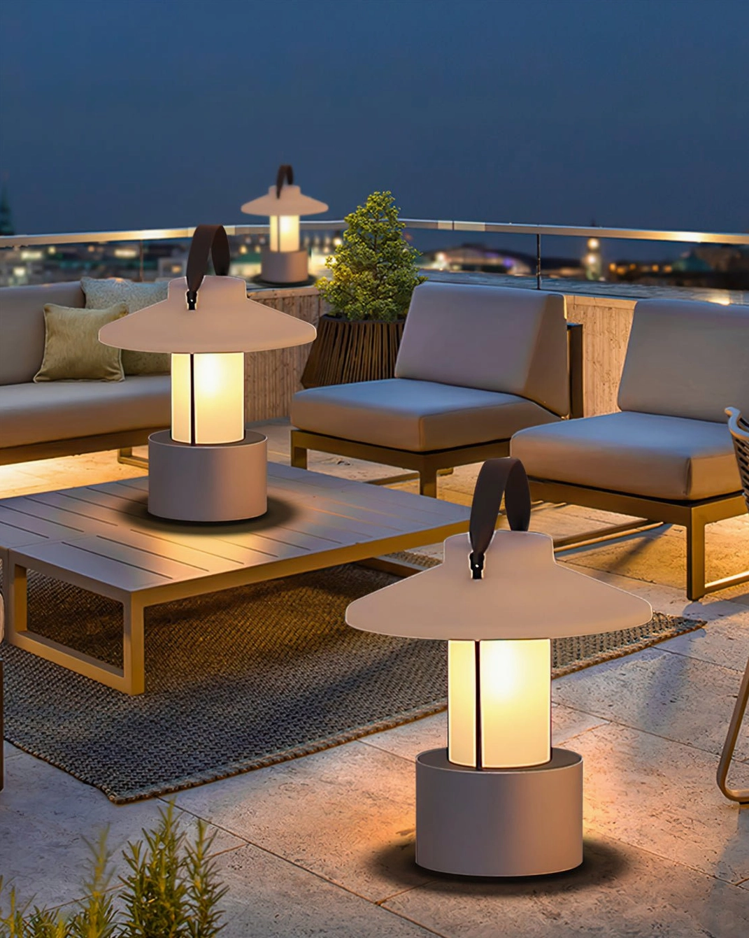 Multiple portable patio lounge lamps creating warm ambient lighting on rooftop seating area