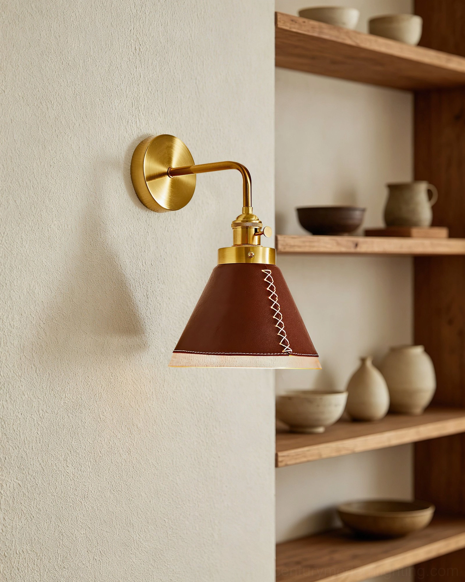 Cordoba wall sconce beside wooden open shelving in rustic farmhouse style interior with warm illumination