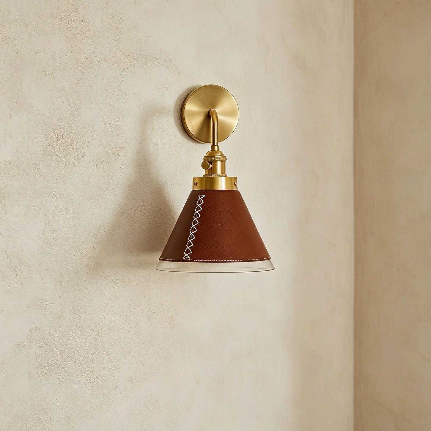 Cordoba wall sconce front view showing minimalist retro design with antique brass frame and brown leather