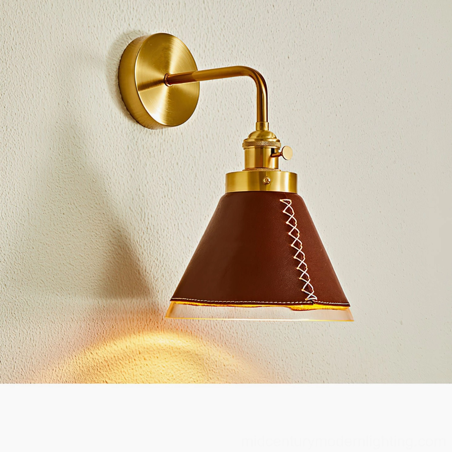 Cordoba wall sconce lit from low angle on plaster wall demonstrating warm accent lighting pool effect