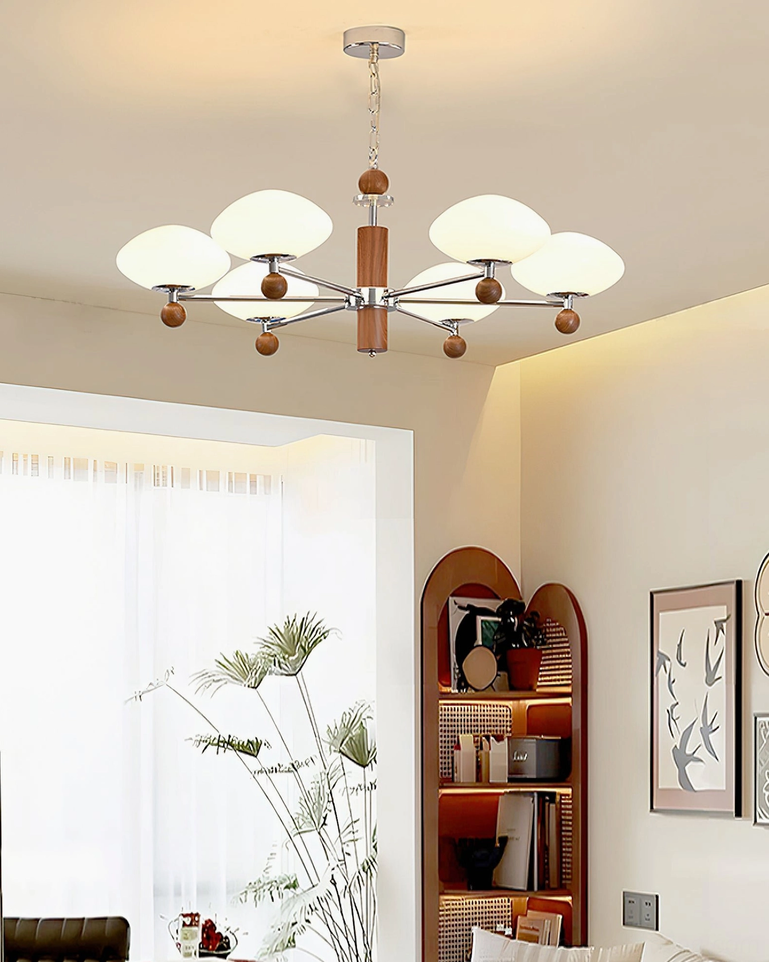 Cozy bedroom with pointed chandelier - mid-century modern pendant light matching neutral retro aesthetic and arched bookshelf