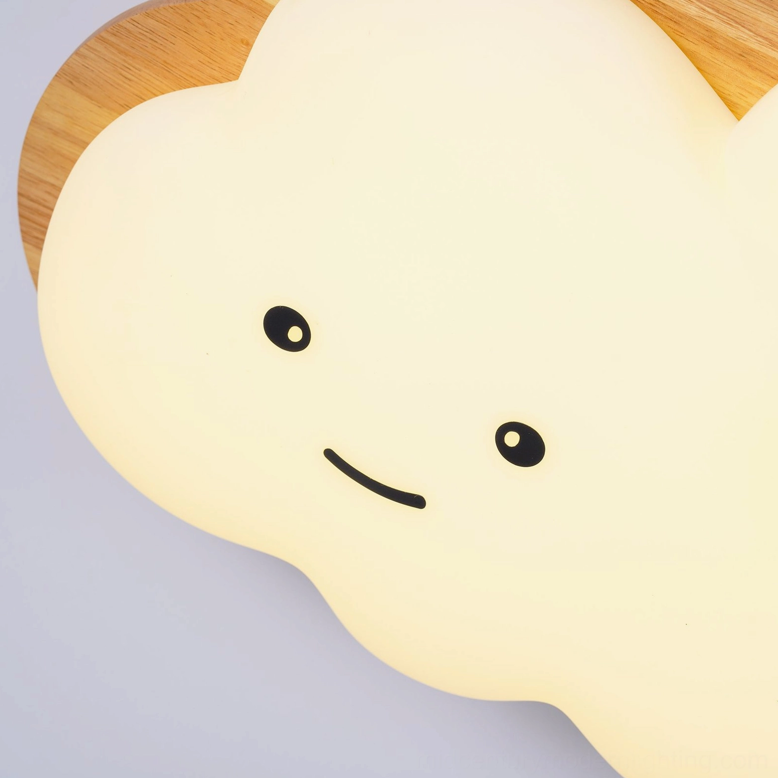 Warm-toned smiling cloud ceiling lamp creating cozy atmosphere in child's bedroom space
