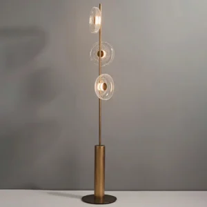 Modern floor lamp with tiered crackle glass shades emitting warm glowing LED light against gray backdrop