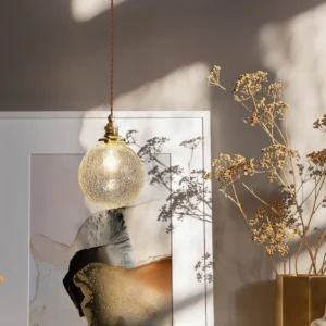 Crackle glass pendant light installed in modern minimalist living room, eye-level hanging perspective with warm neutral decor