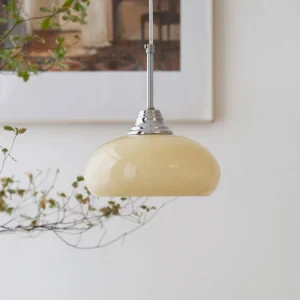 Cream Bell Pendant Light hanging in vintage-inspired home with dried botanical decor and wall art