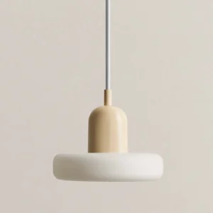 Cream colored curling pendant light with soft diffusion shade, close-up view against warm beige wall, scandinavian minimalist style