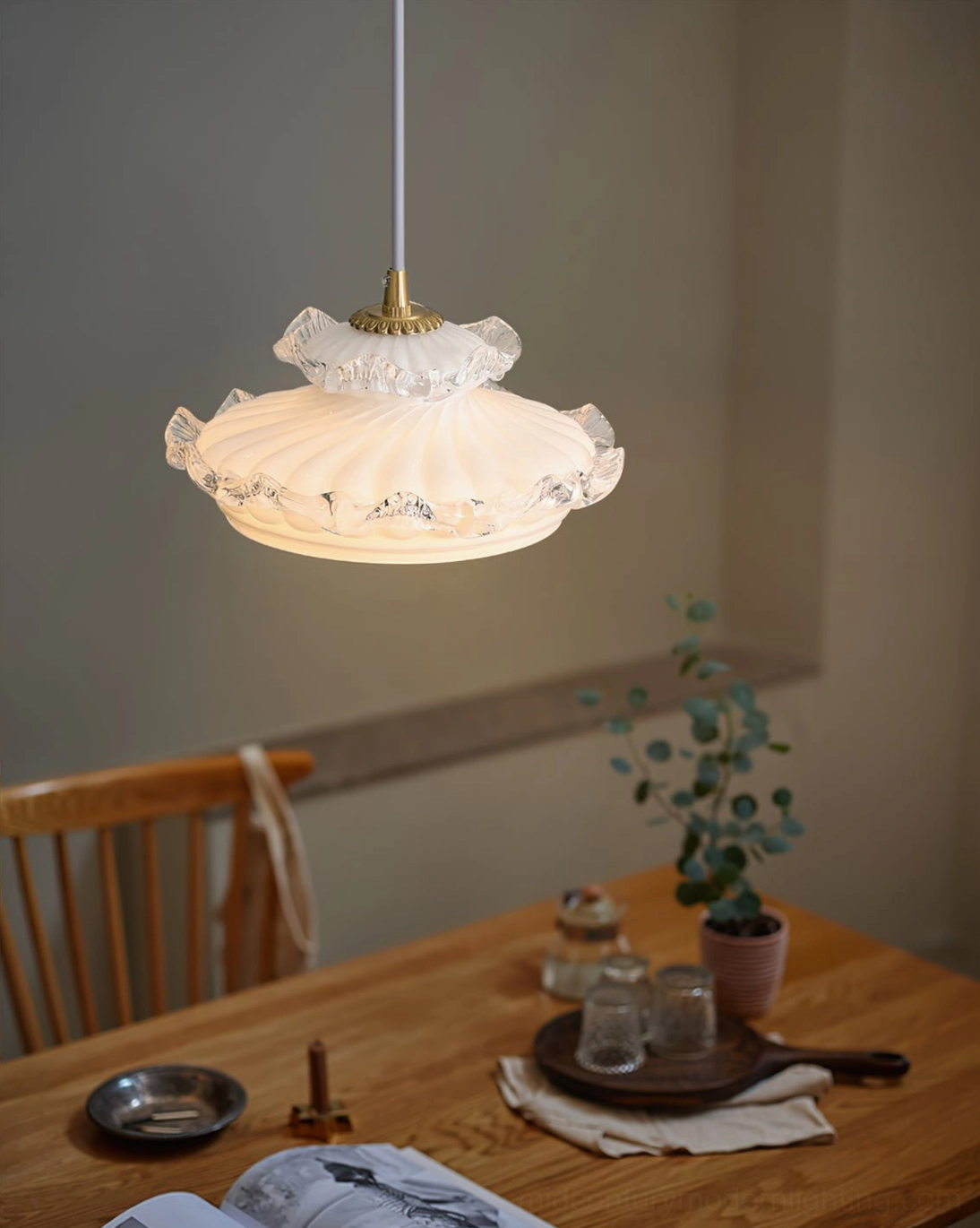 Cream frosted pendant lamp creating warm ambient lighting in contemporary interior space