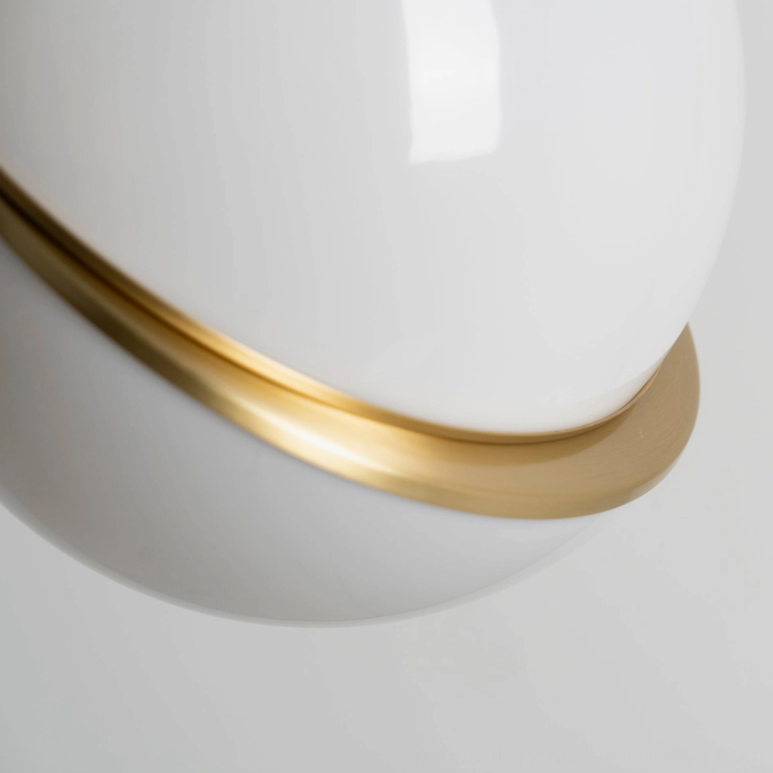 Crescent pendant light creating ambient illumination in sophisticated interior space
