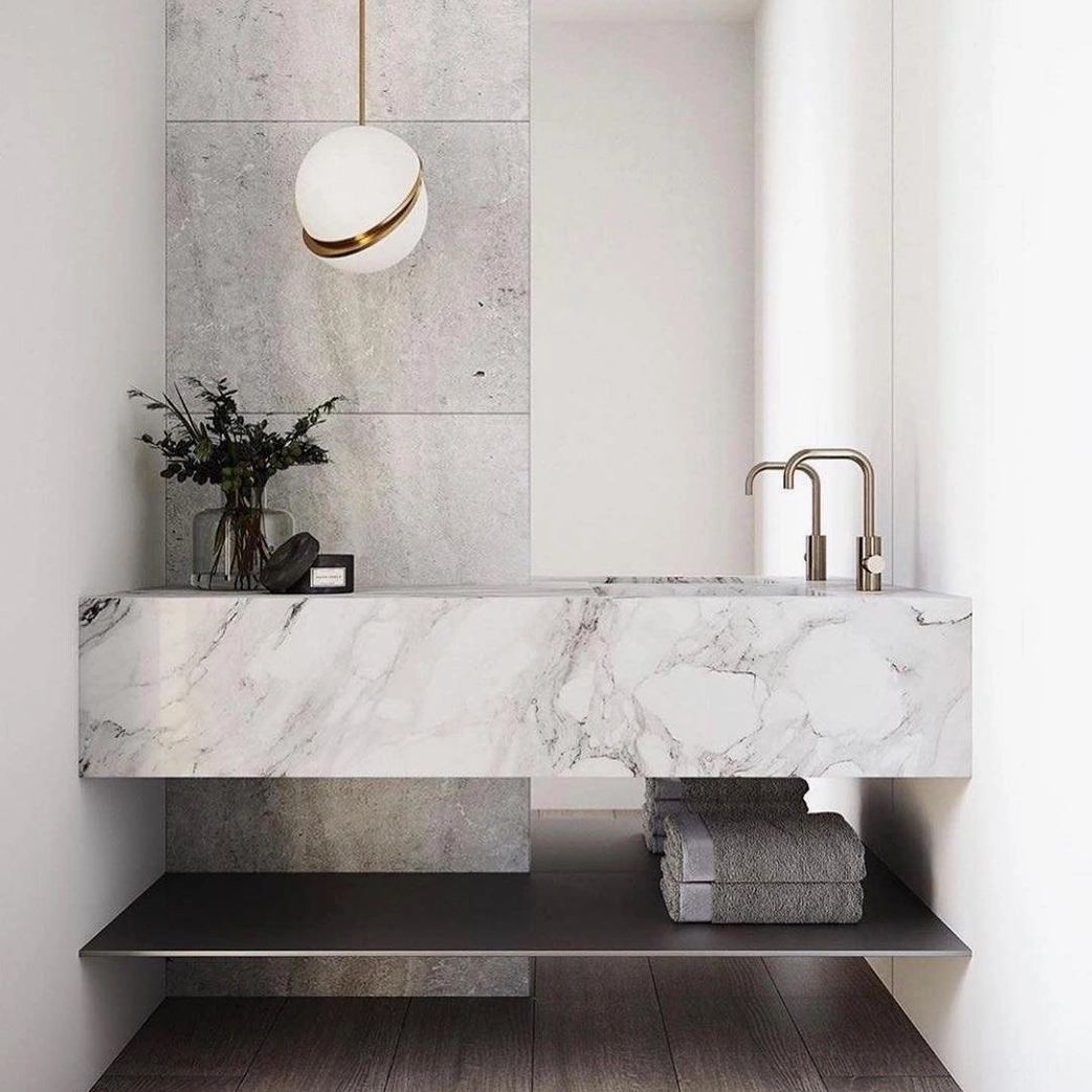 Crescent pendant light in minimalist luxury marble bathroom with neutral decor