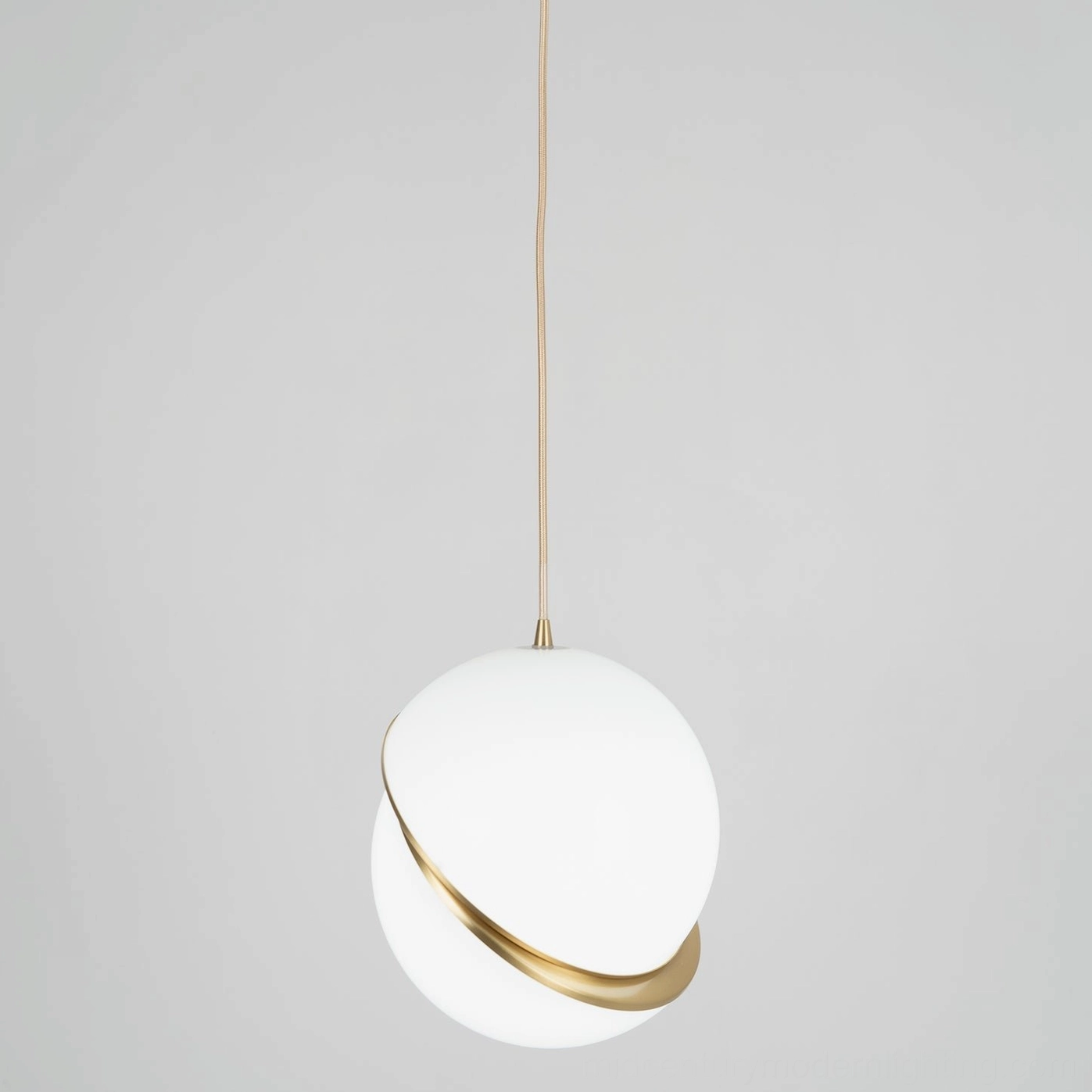 Modern opal crescent pendant light with gold trim and clean geometric form