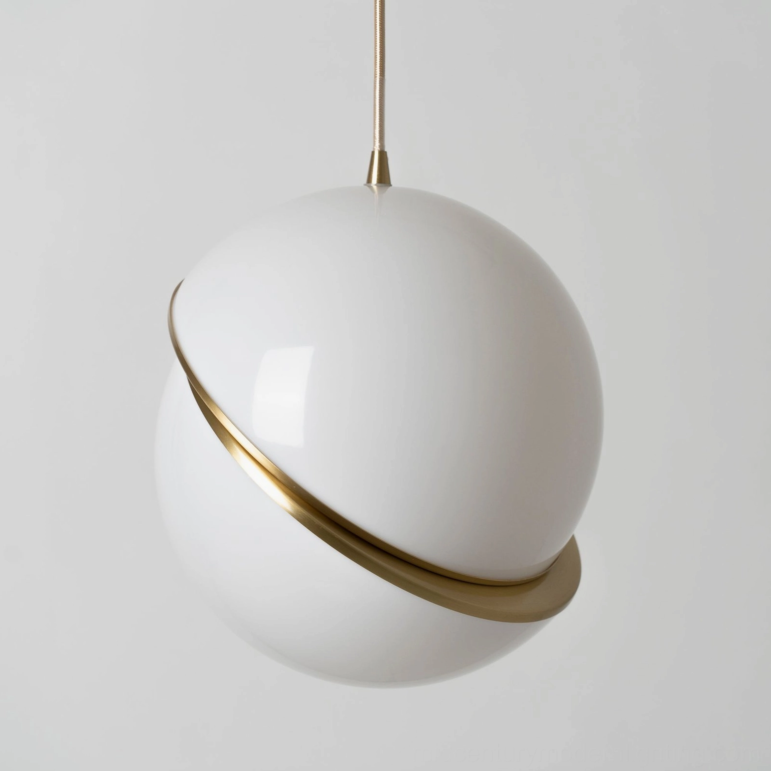 Single crescent pendant light installed in modern minimalist residential setting