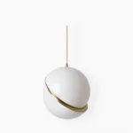Crescent pendant light with opal white sphere and brushed gold fascia on white studio background