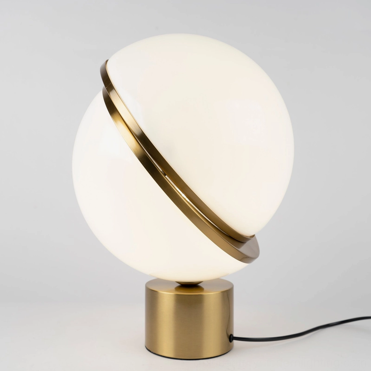 Crescent Sphere Table Light front flat view showing attached power cord and brushed brass metal base