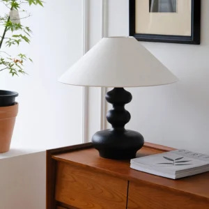 Crigler table lamp styled on bedroom nightstand with contemporary decor and wall art