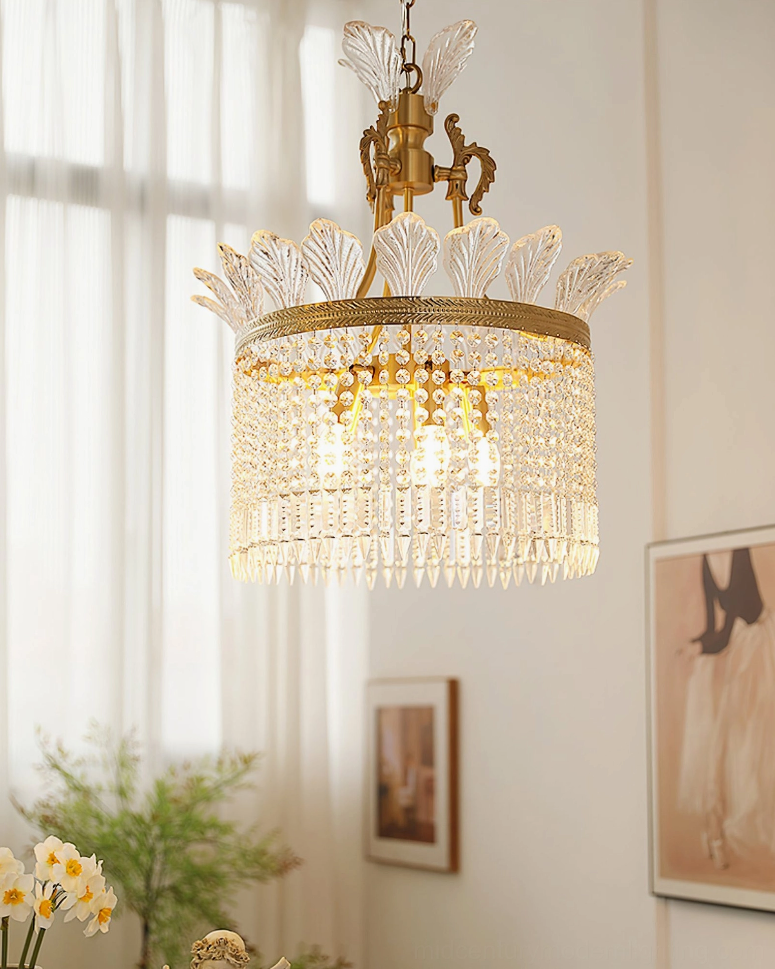 Brass chandelier with thick crystal pendants and warm glowing lights in home decor