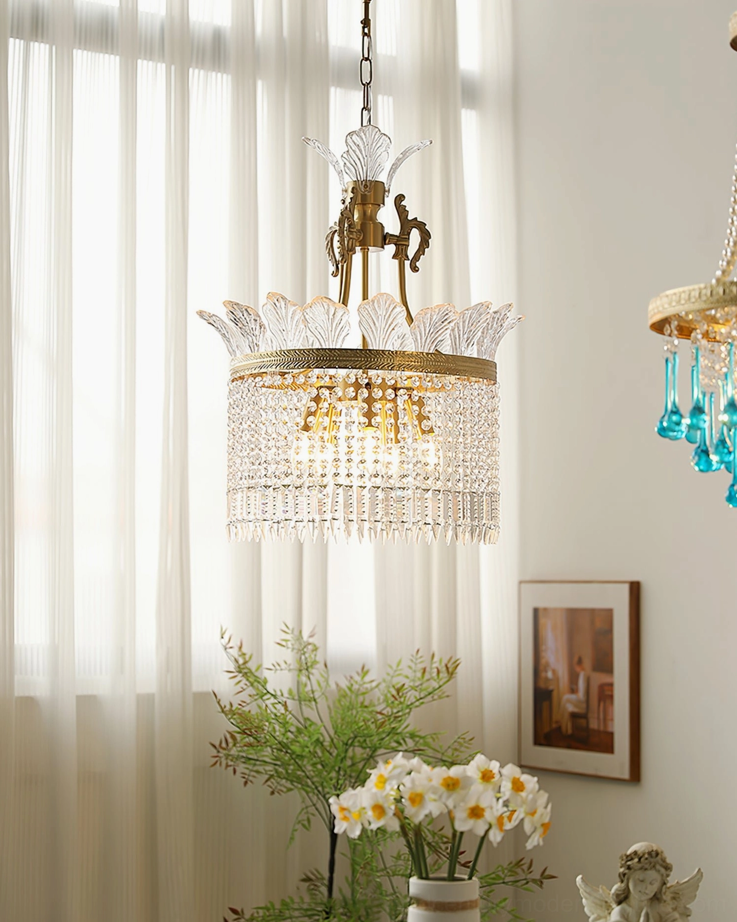 Side view of mid-century modern brass chandelier with tiered glass pendants in styled room