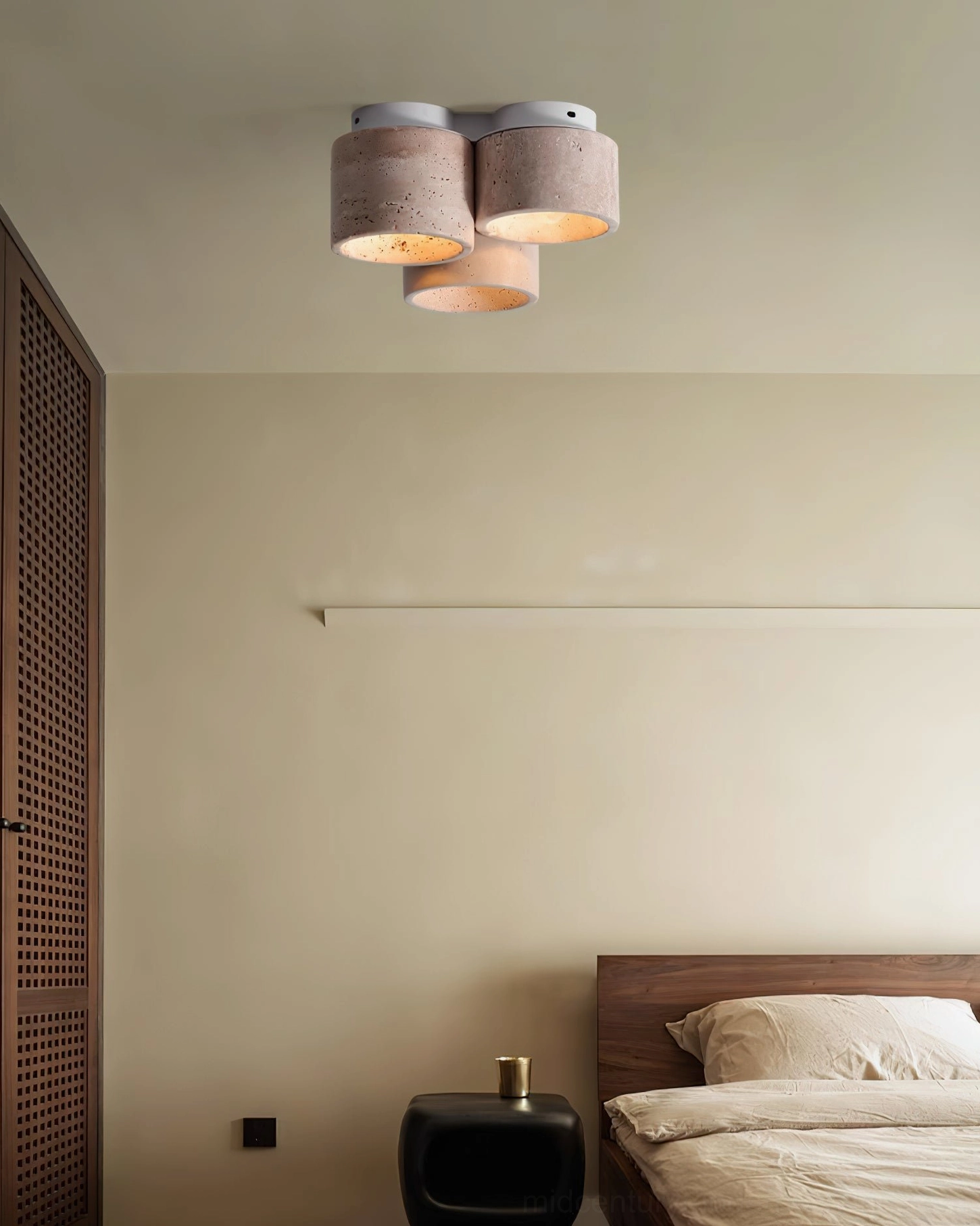 Cromia travertine ceiling fixture mounted in contemporary bedroom providing warm diffused lighting over bed