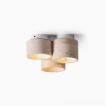 Cromia natural travertine three-light ceiling fixture shown against white background, showcasing cylindrical stone shades with warm wood base