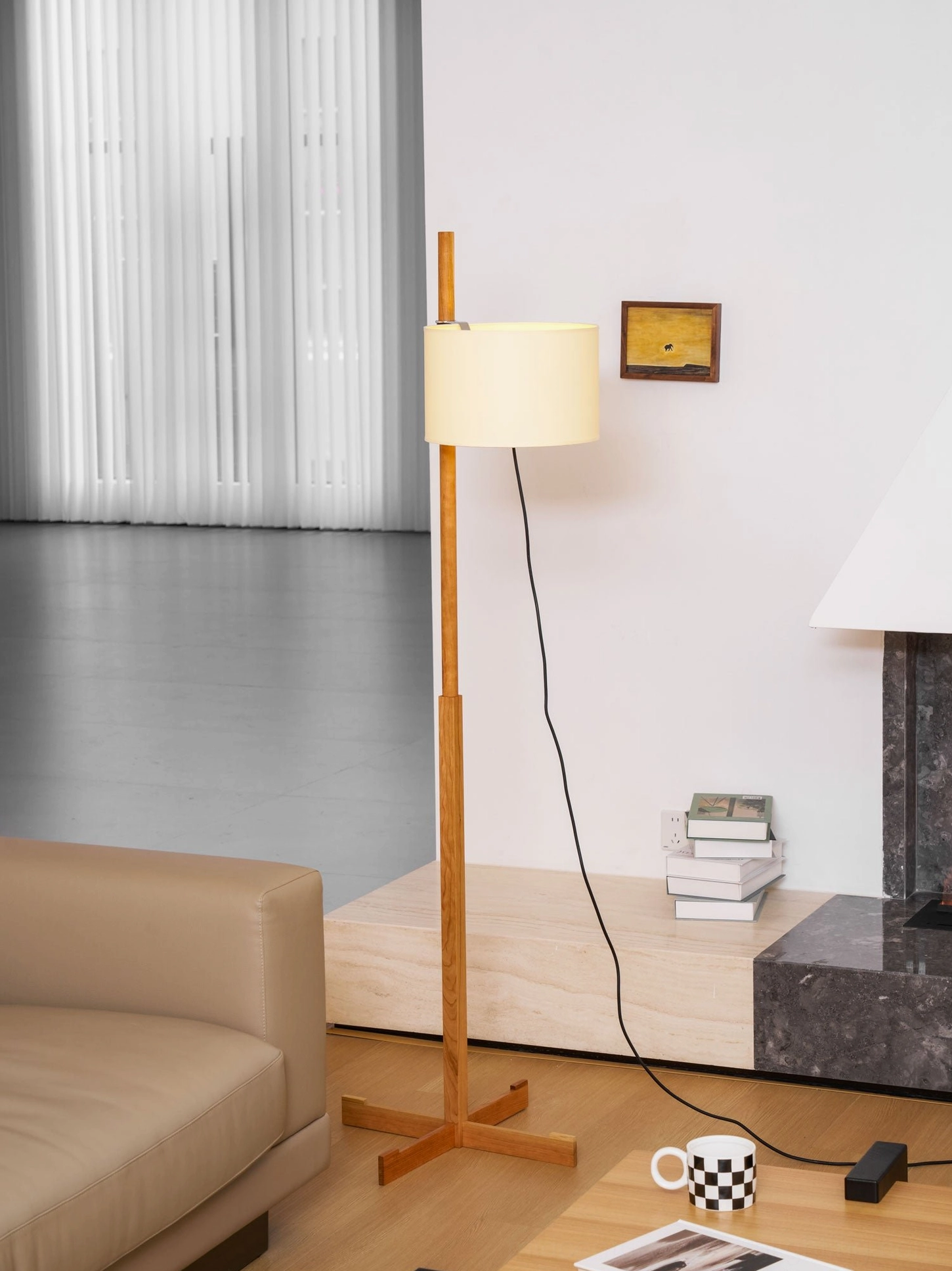 Wooden floor lamp featuring minimalist cross-shaped base in contemporary interior