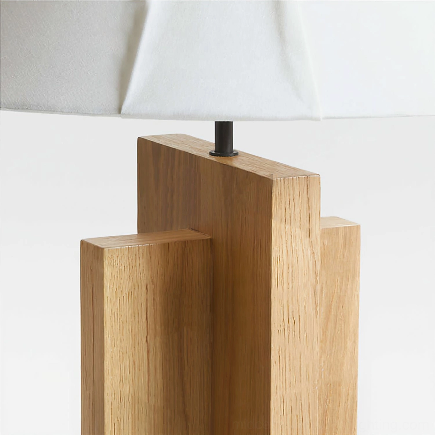 Geometric wooden base close-up showing staggered solid wood blocks and matte black metal connectors