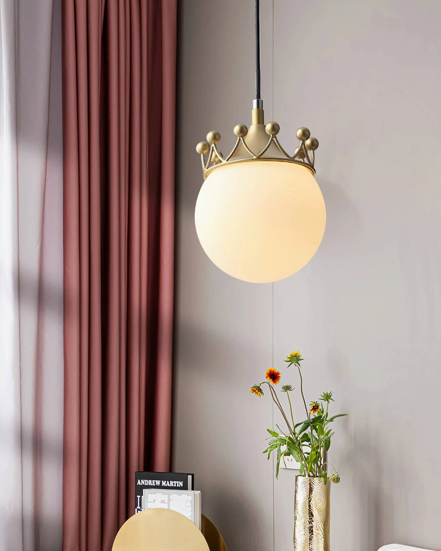 Crown globe pendant ceiling light with brass gold finish and frosted glass shade in contemporary bedroom environment
