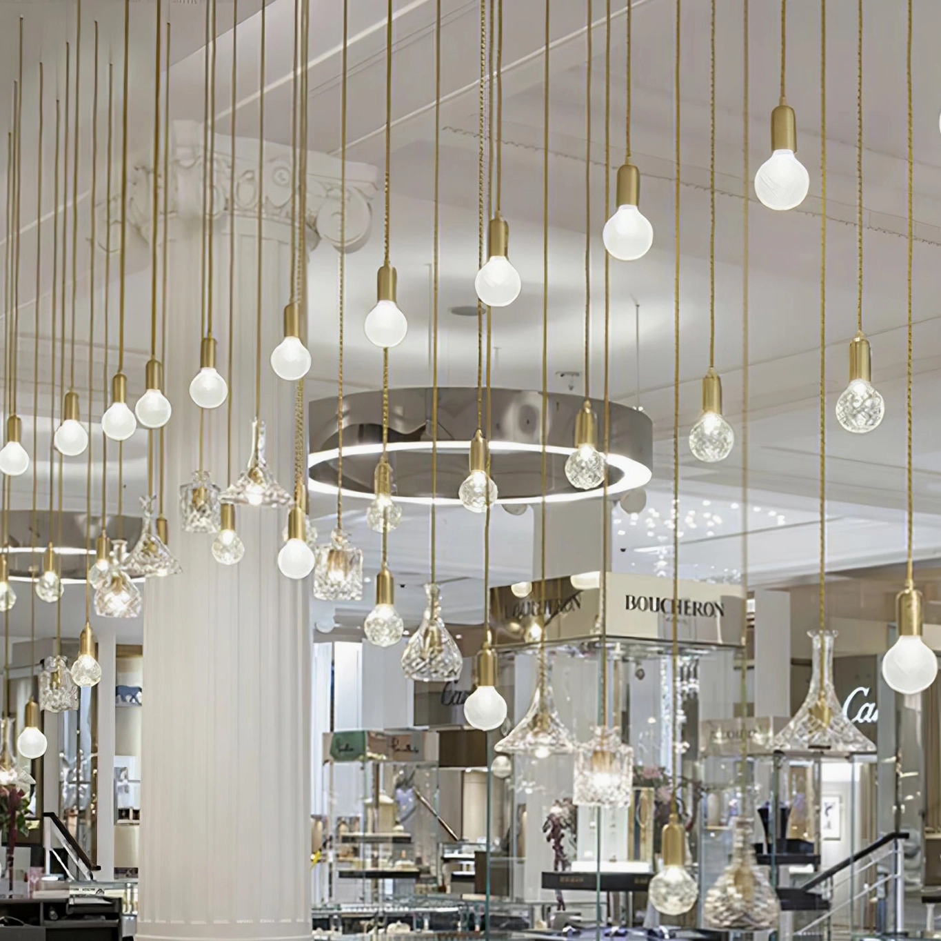 Commercial installation of multiple crystal bulb pendants in luxury retail space