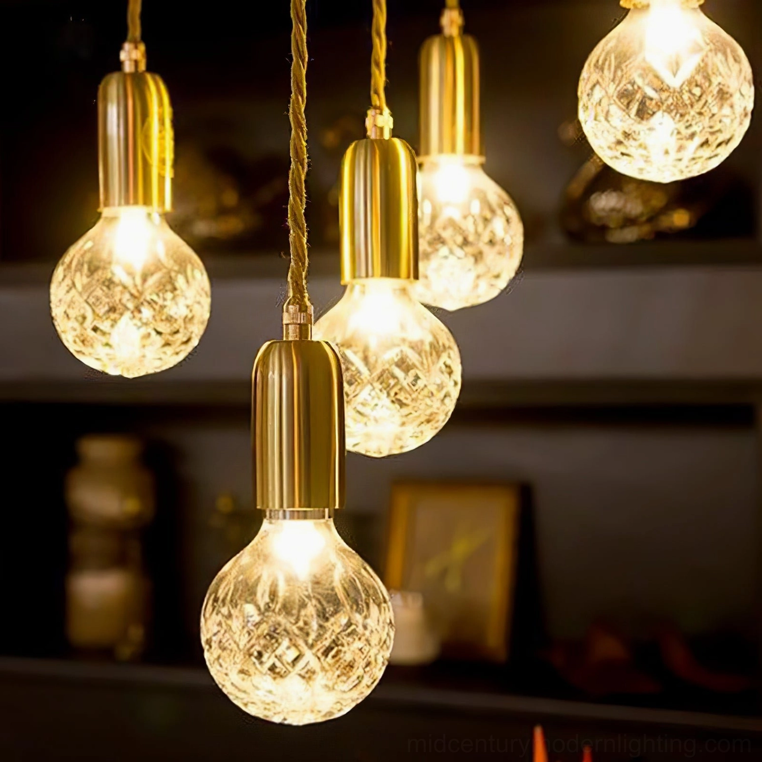 Macro close-up of hand-cut crystal facets on bulb pendant with brass top and gold cord